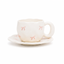Tasse en céramique blanche et rose avec motif de nœuds et soucoupe assortie